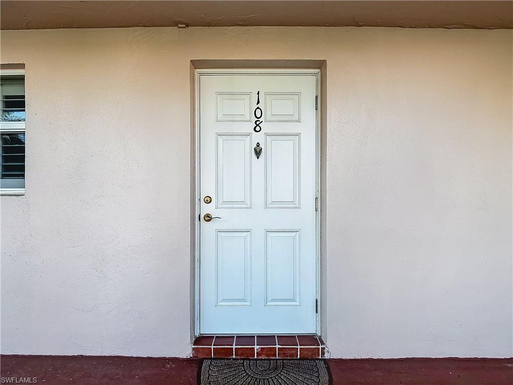 175 Turtle Lake Court, Unit 108 Naples, FL 34105 - Photo 1 of 17 Property entrance featuring stucco siding