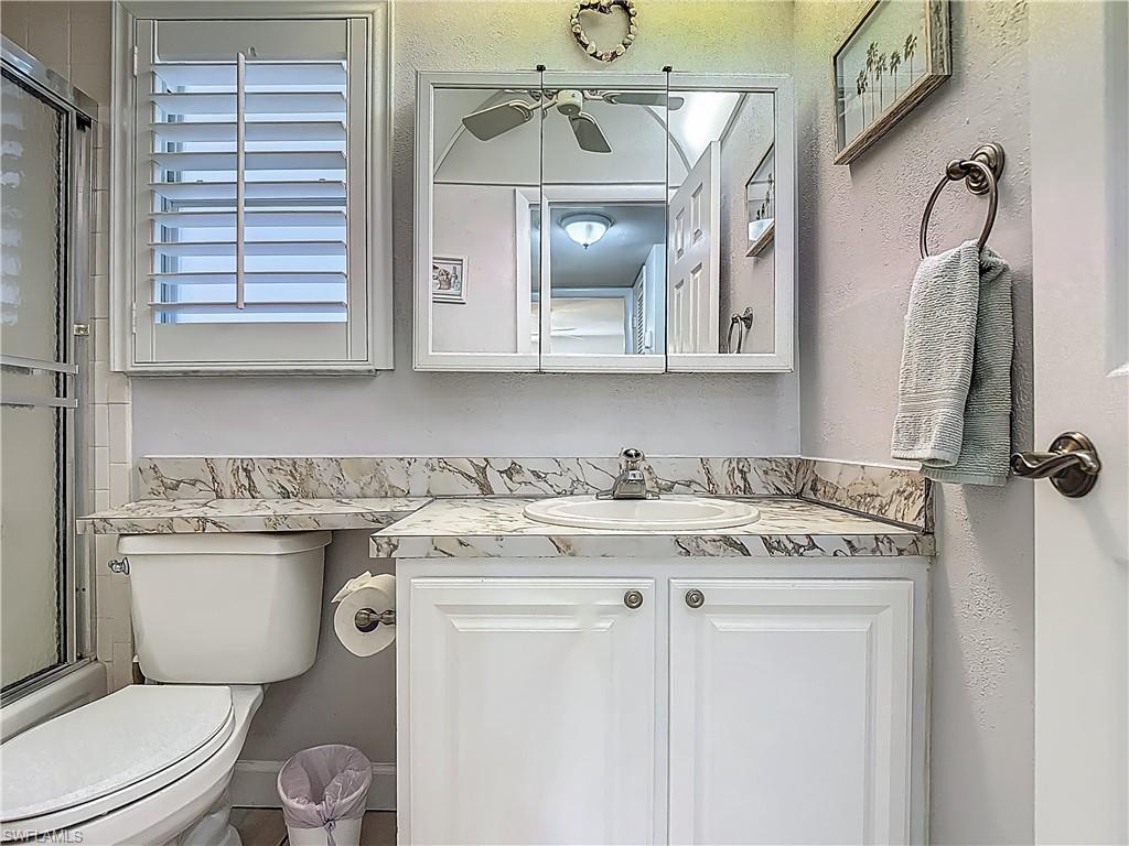 175 Turtle Lake Court, Unit 108 Naples, FL 34105 - Photo 14 of 17 Full bathroom featuring vanity and toilet
