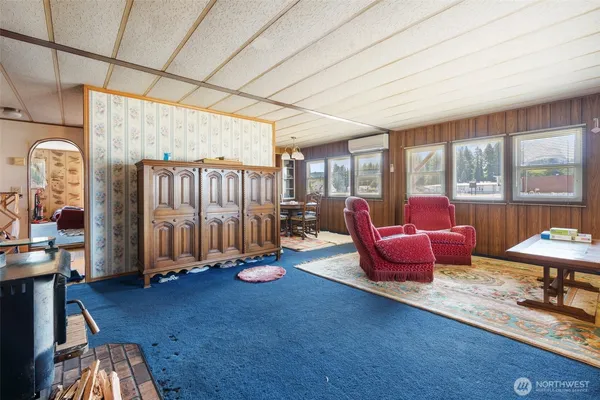 a living room with furniture a rug and a large window