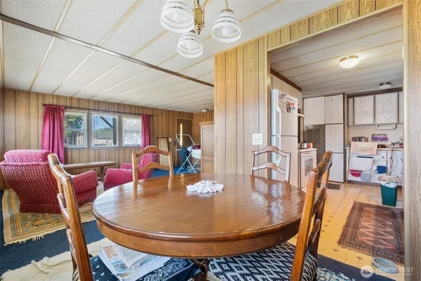 a dining room with furniture and wooden floor