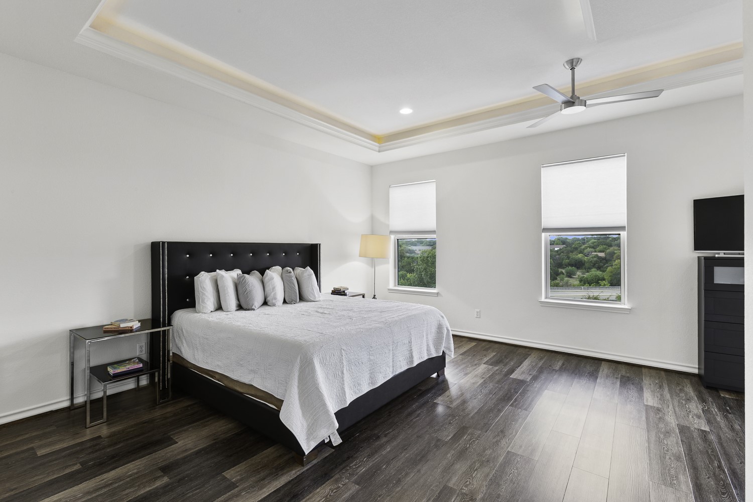 221 Adams Street Georgetown, TX 78628 - Photo 11 of 35 a large bedroom with a bed and wooden floor