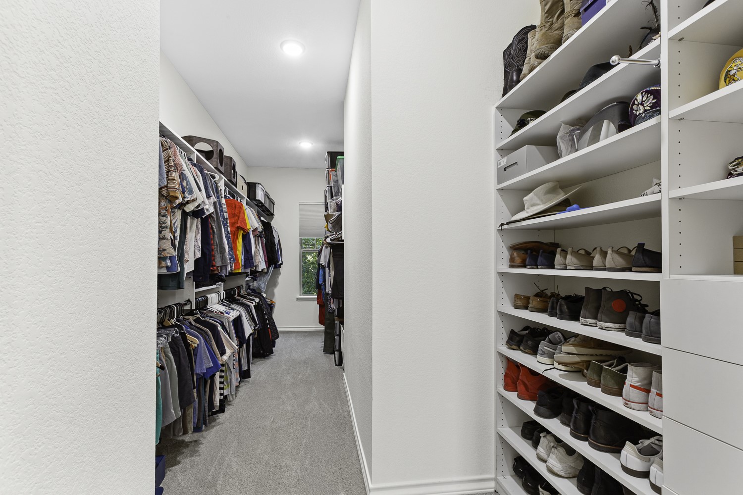 221 Adams Street Georgetown, TX 78628 - Photo 17 of 35 a view of walk in closet with clothes and shoes