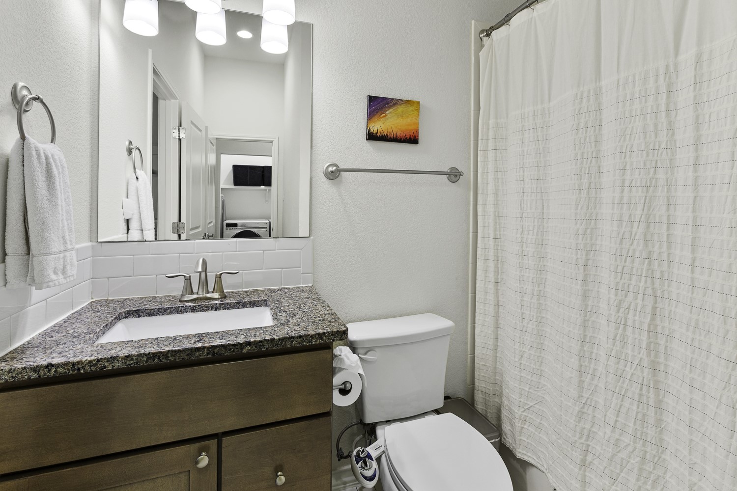 221 Adams Street Georgetown, TX 78628 - Photo 20 of 35 a bathroom with a granite countertop sink and a mirror with toilet