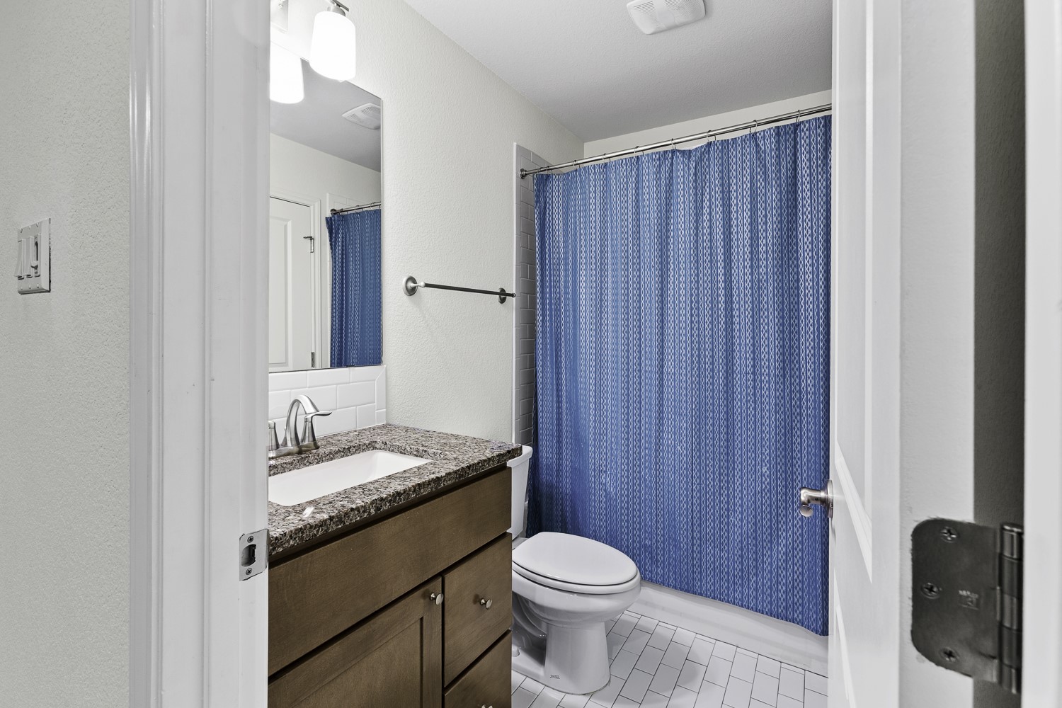 221 Adams Street Georgetown, TX 78628 - Photo 26 of 35 a bathroom with a granite countertop sink toilet and mirror