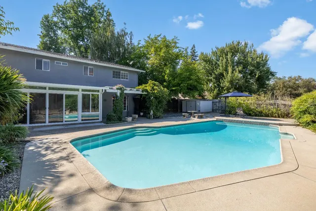 a front view of house with yard and outdoor seating