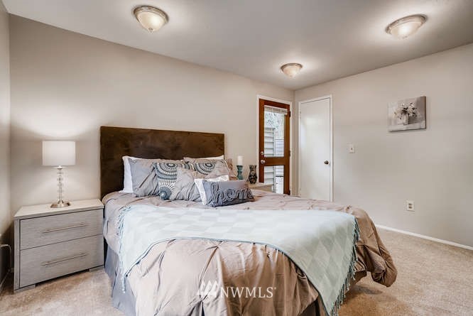 13801 Old Redmond Road, Unit A101 Redmond, WA 98052 - Photo 13 of 25 a bedroom with a bed and a night stand