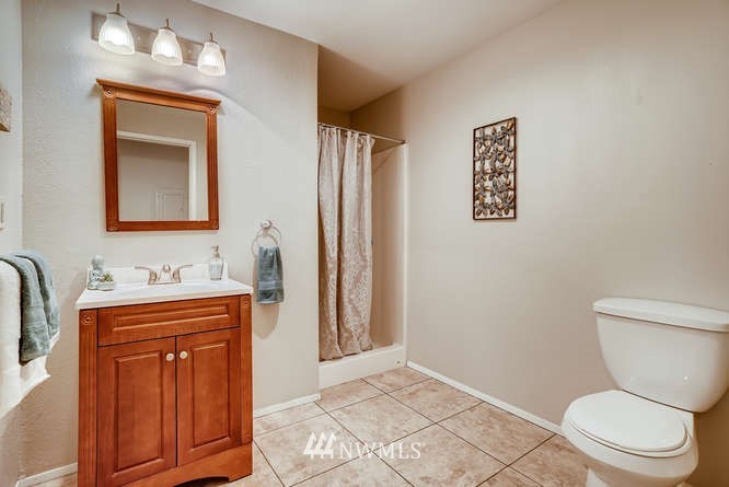 13801 Old Redmond Road, Unit A101 Redmond, WA 98052 - Photo 14 of 25 a bathroom with a toilet a sink and mirror