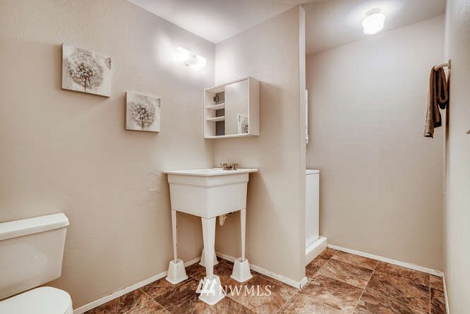 13801 Old Redmond Road, Unit A101 Redmond, WA 98052 - Photo 16 of 25 a bathroom with a toilet sink and mirror