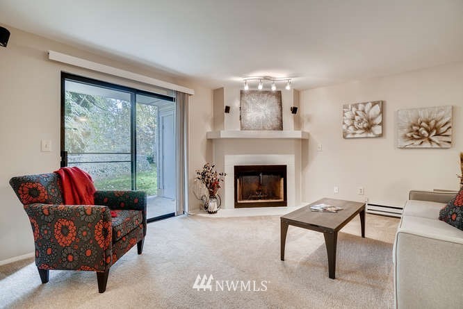 13801 Old Redmond Road, Unit A101 Redmond, WA 98052 - Photo 4 of 25 a living room with furniture and a fireplace