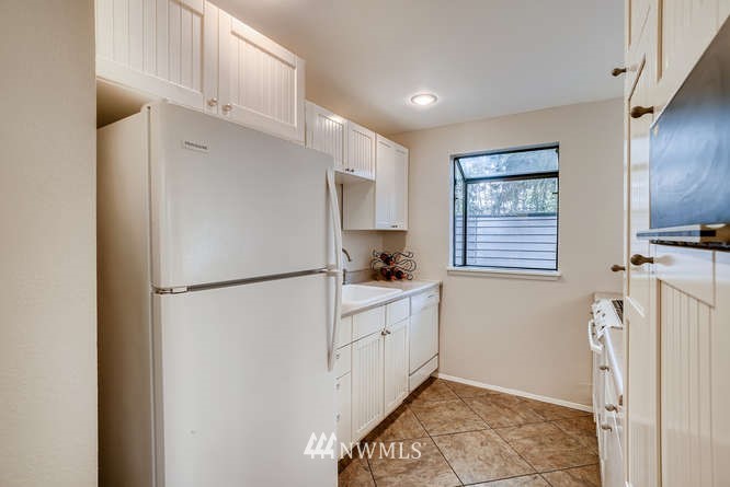 13801 Old Redmond Road, Unit A101 Redmond, WA 98052 - Photo 5 of 25 a kitchen with stainless steel appliances a refrigerator sink and cabinets