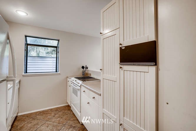 13801 Old Redmond Road, Unit A101 Redmond, WA 98052 - Photo 6 of 25 a view of kitchen with stainless steel appliances cabinets and a window