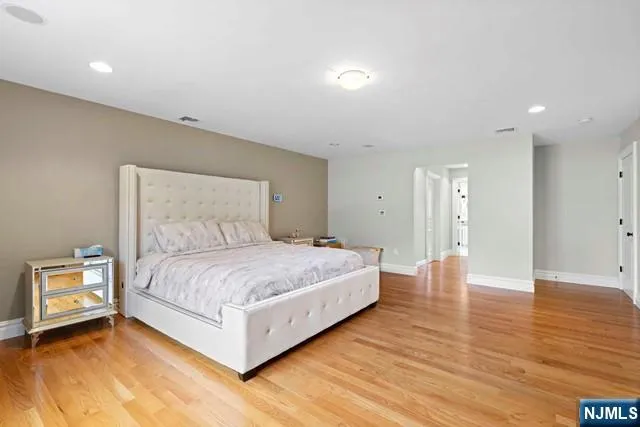 a bedroom with a bed and a night stand