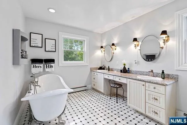 a bathroom with a bathtub sink mirror and toilet