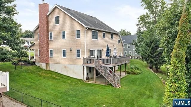 a view of a house with a yard and deck