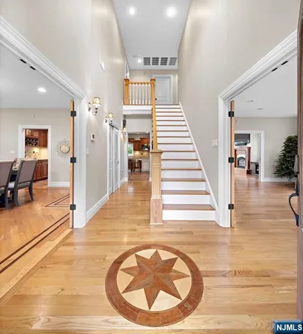 a view of a hallway with dining room and stairs