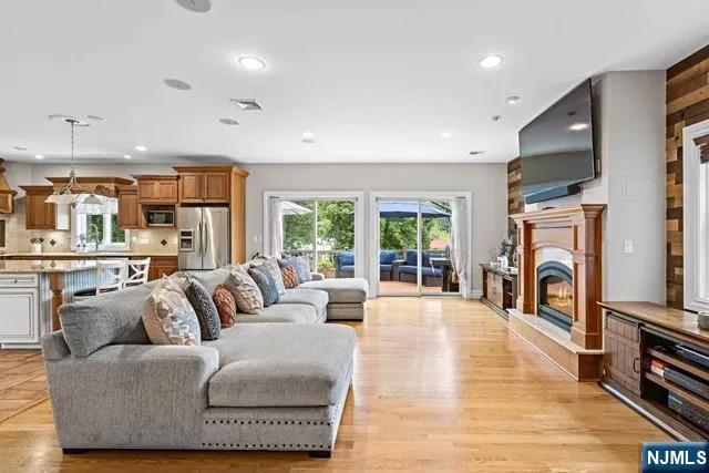 a living room with furniture a fireplace and a flat screen tv