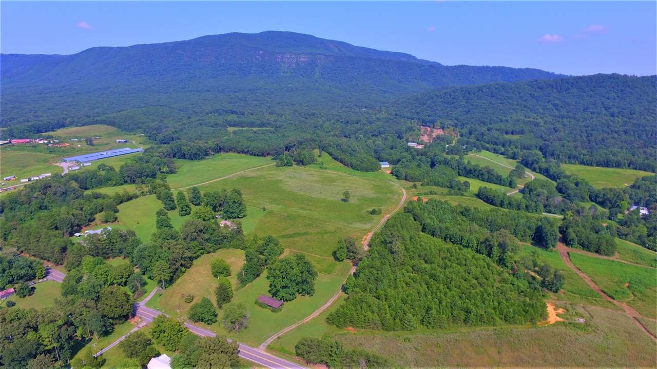 700 Parksville Road Benton, TN 37307 - Photo 3 of 39 a view of a lush green hillside and a building