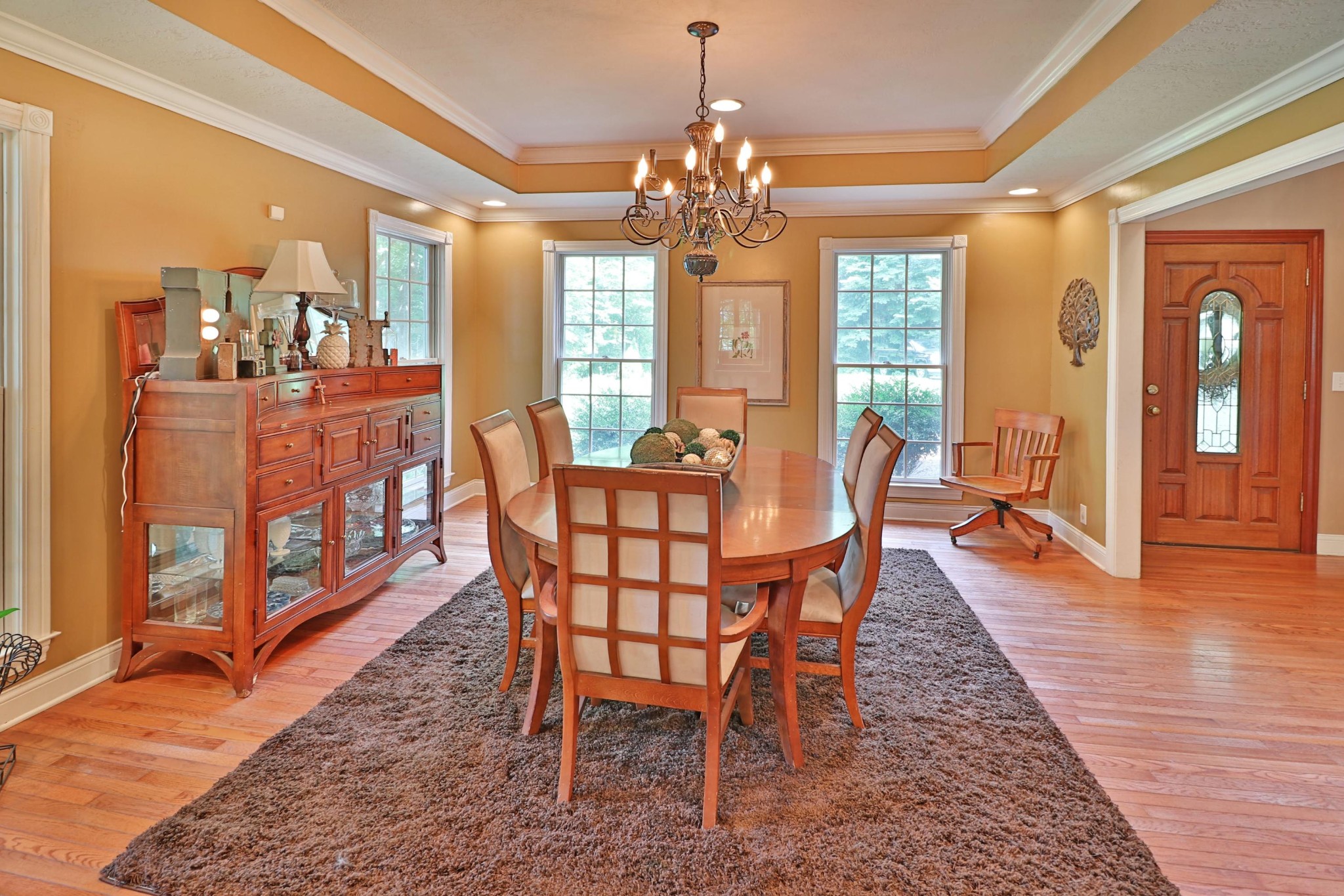281 Lone Ridge Lane Clinton, TN 37716 - Photo 2 of 40 a dining room with wooden floor a chandelier a wooden table and chairs