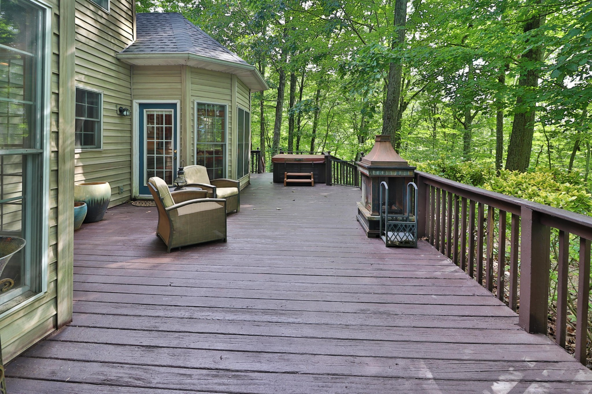 281 Lone Ridge Lane Clinton, TN 37716 - Photo 32 of 40 a view of a patio with couches chairs and wooden floor
