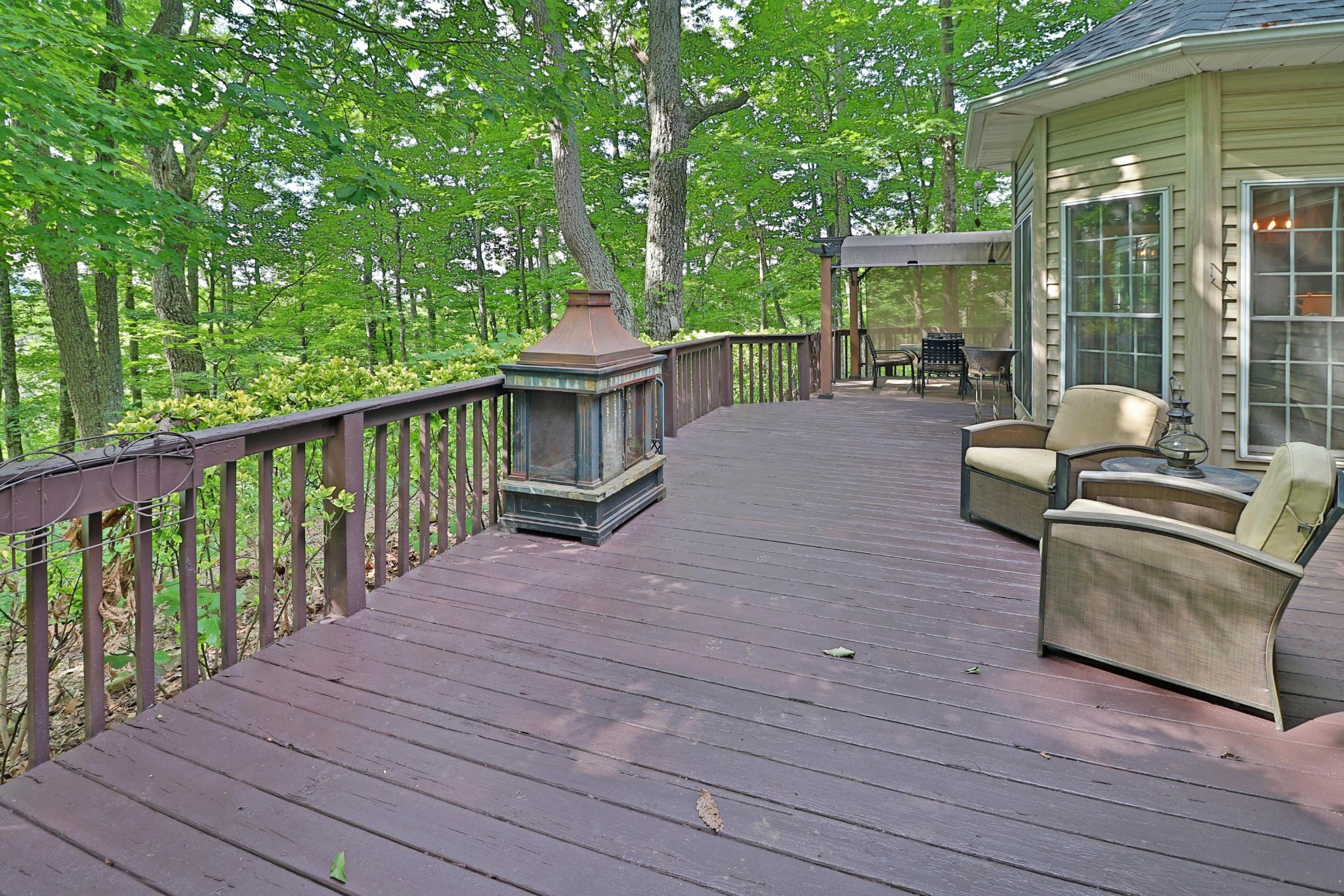281 Lone Ridge Lane Clinton, TN 37716 - Photo 34 of 40 a view of a patio with couches chairs and wooden floor