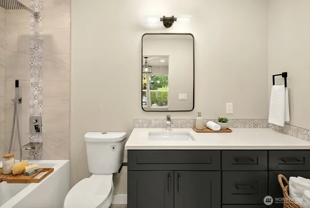 a bathroom with a toilet sink and mirror