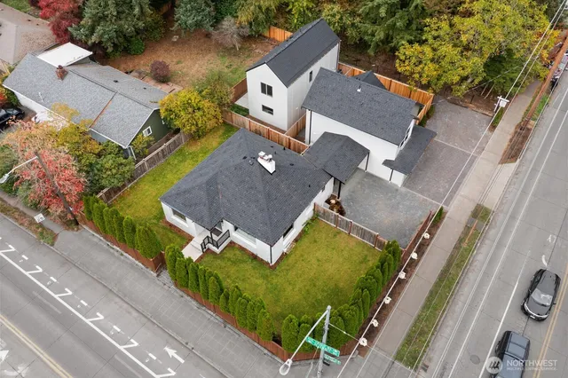 an aerial view of a house with garden space and parking
