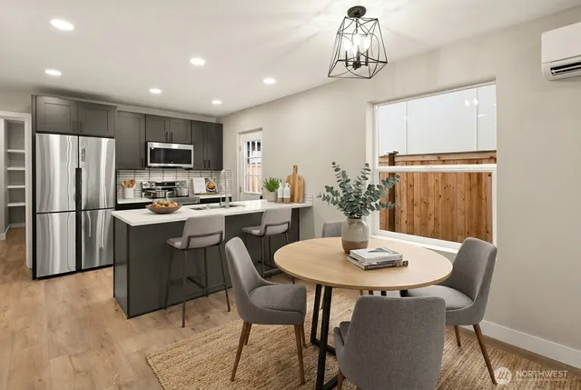 a kitchen with a dining table chairs and refrigerator