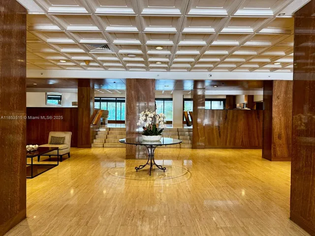 a living room with lots of furniture and a kitchen view