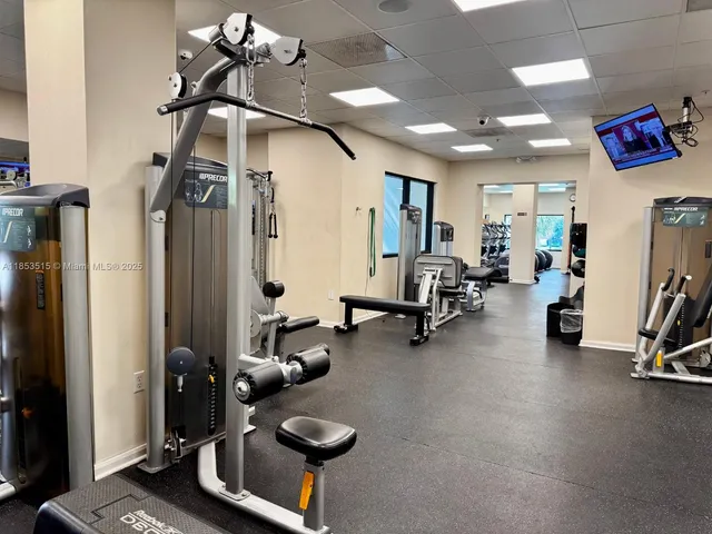 a room with gym equipment and a mirror