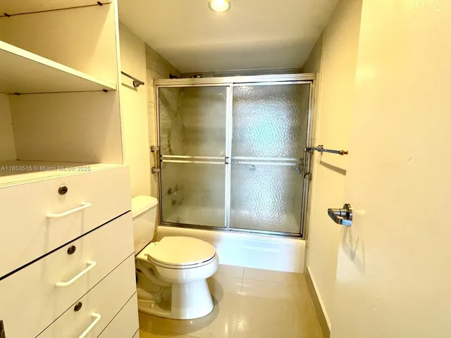 a bathroom with a shower and a toilet