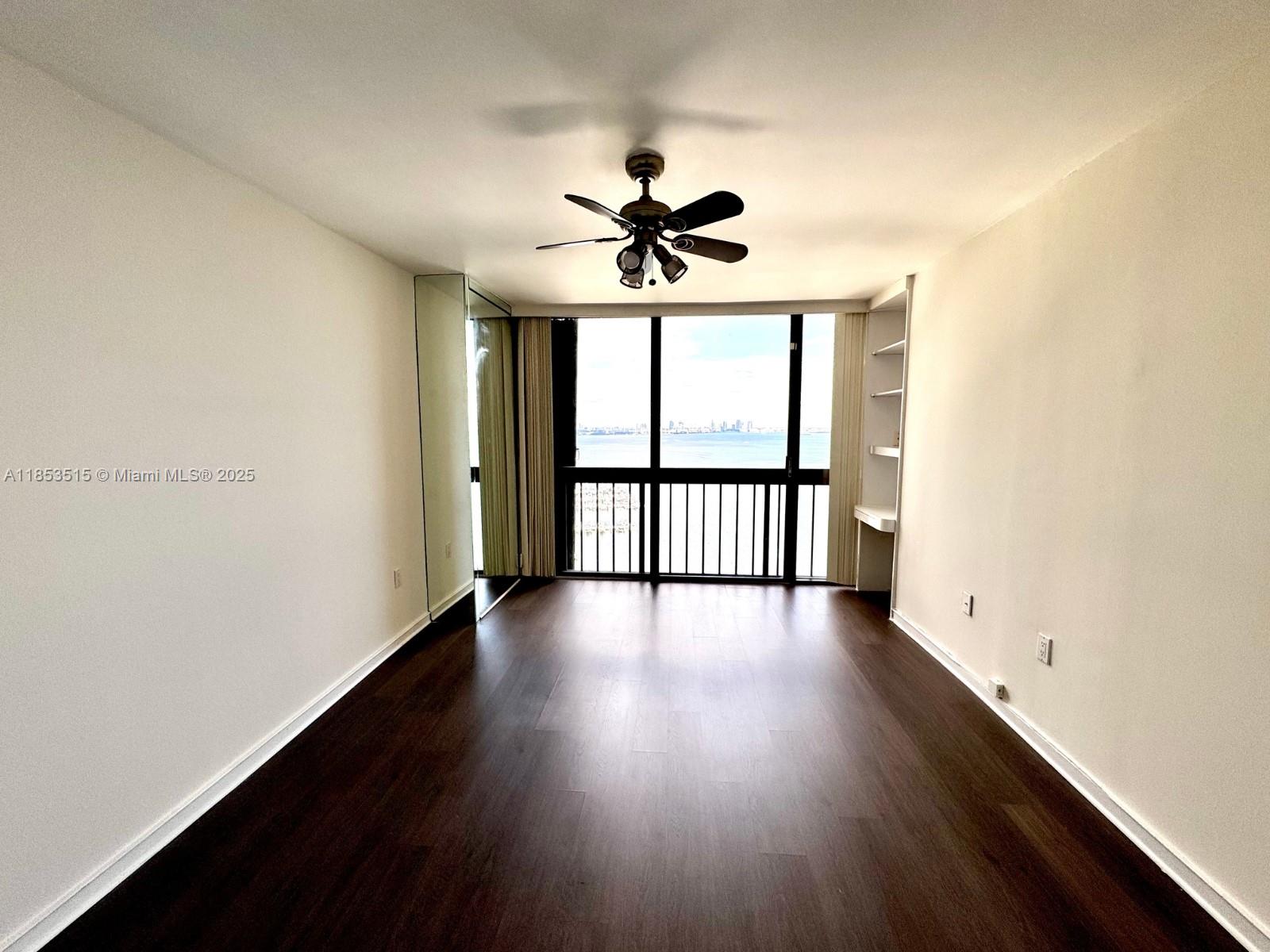 2333 Brickell Avenue, Unit 2607 Miami, FL 33129 - Photo 10 of 23 wooden floor in an empty room with a window