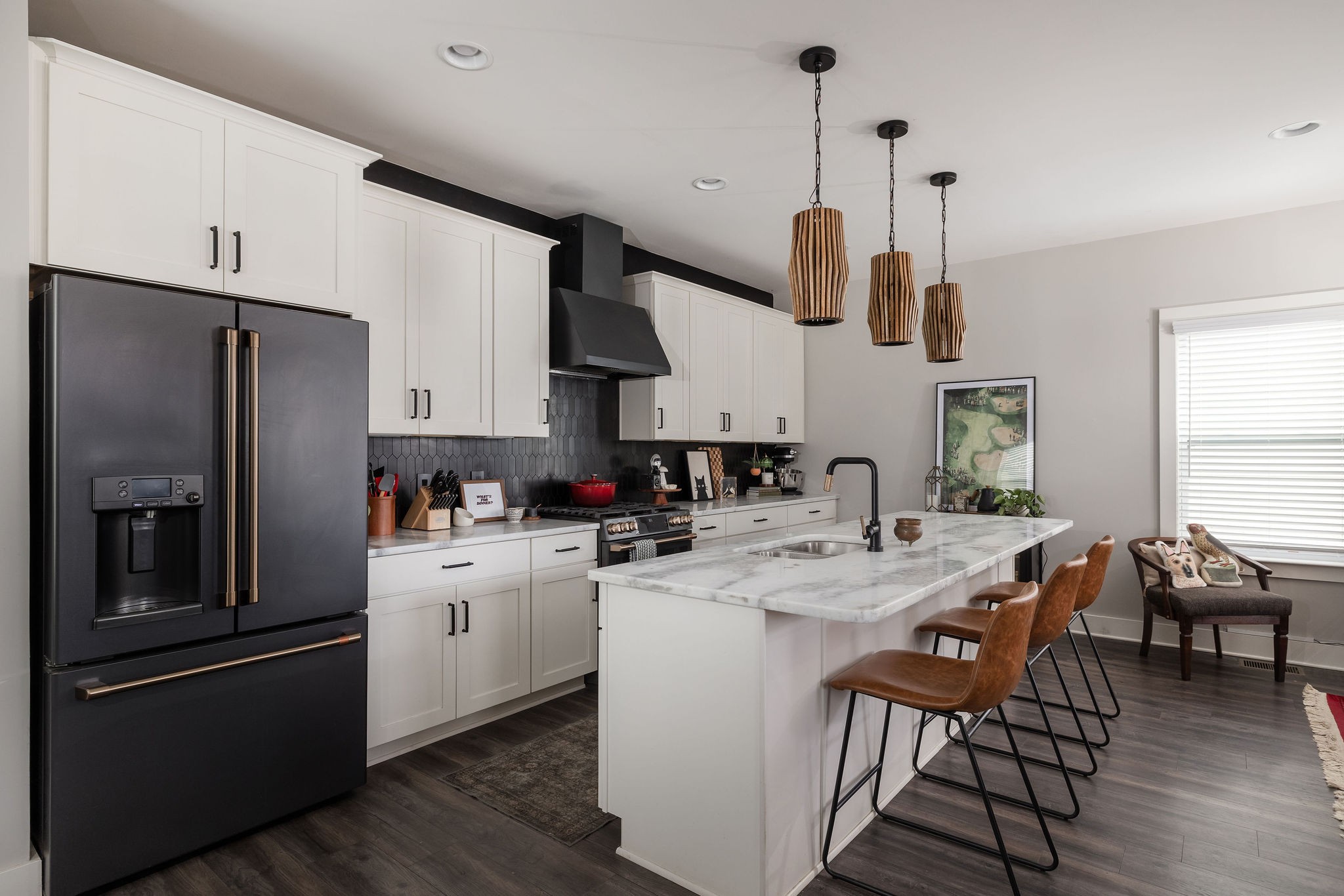 3415 Old Anderson Road Antioch, TN 37013 - Photo 3 of 46 a kitchen with stainless steel appliances kitchen island granite countertop a refrigerator a sink a stove and white cabinets with wooden floor