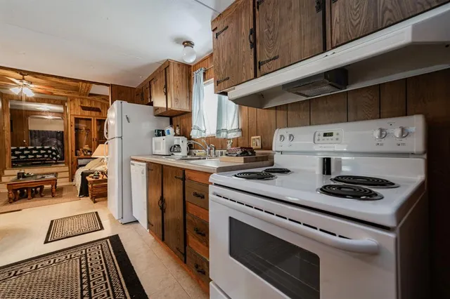 a kitchen with stainless steel appliances a stove a sink and a refrigerator