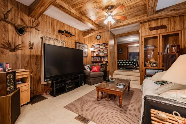 a outdoor living space with furniture and a flat screen tv