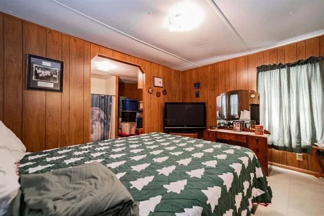 a bedroom with a large bed and a dresser