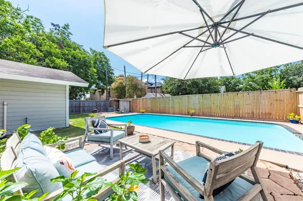 a backyard of a house with yard and outdoor seating