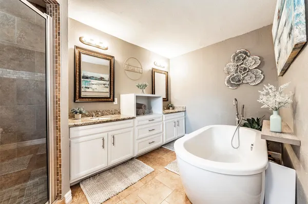 a bathroom with cabinets granite and a sink