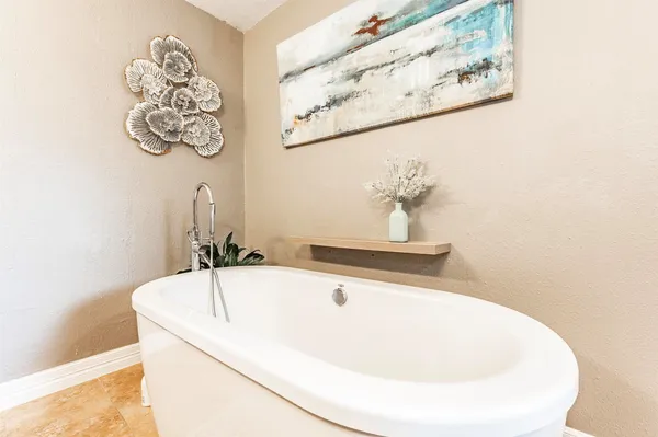 a spacious bathroom with a tub shower and toilet