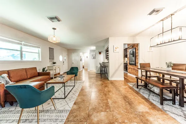 a living room with furniture and a dining table