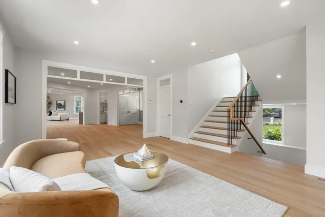 a living room with lots of furniture and kitchen view