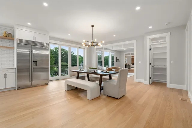a large white kitchen with a large window