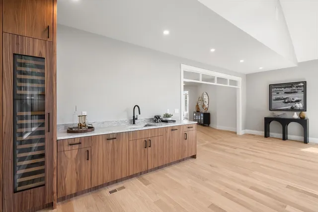 a kitchen with stainless steel appliances granite countertop a table chairs sink refrigerator and cabinets