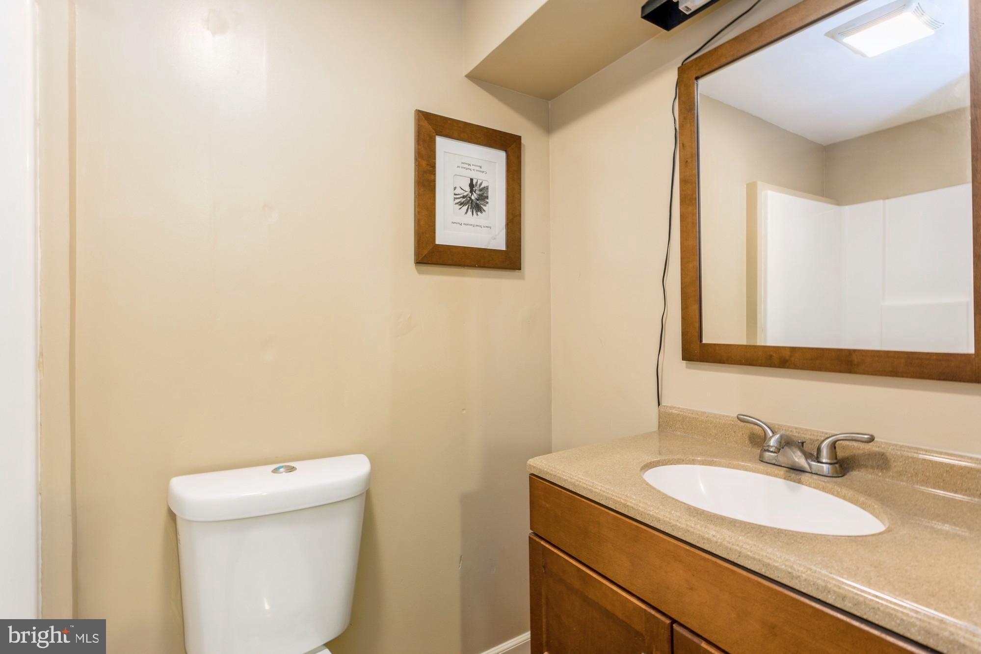 220 Drexel Drive Bel Air, MD 21014 - Photo 38 of 55 a bathroom with a granite countertop toilet sink and mirror
