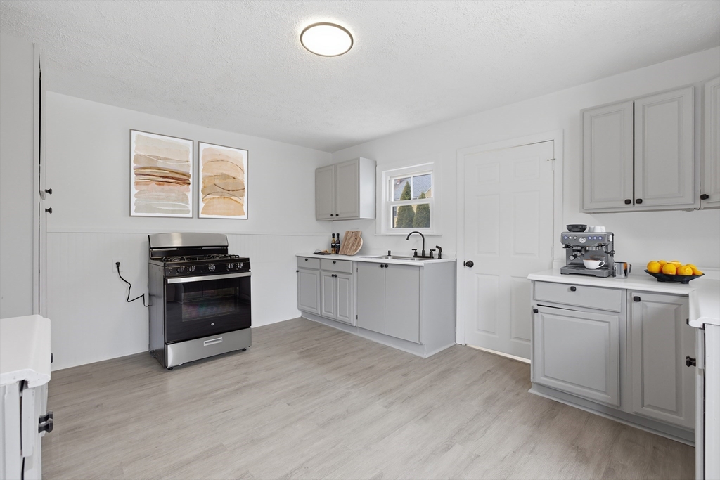 2120 Providence Road Northbridge, MA 01534 - Photo 3 of 12 a kitchen with granite countertop a sink cabinets and stainless steel appliances