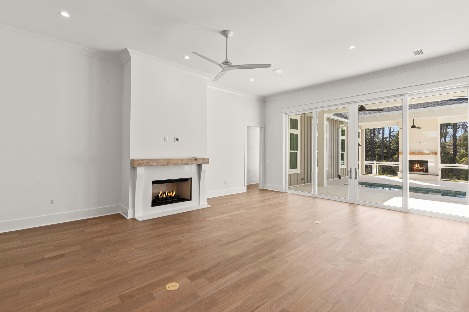 74 Pollard Cove West, Unit LOT 41 Watersound, FL 32461 - Photo 18 of 62 an empty room with wooden floor fireplace and windows