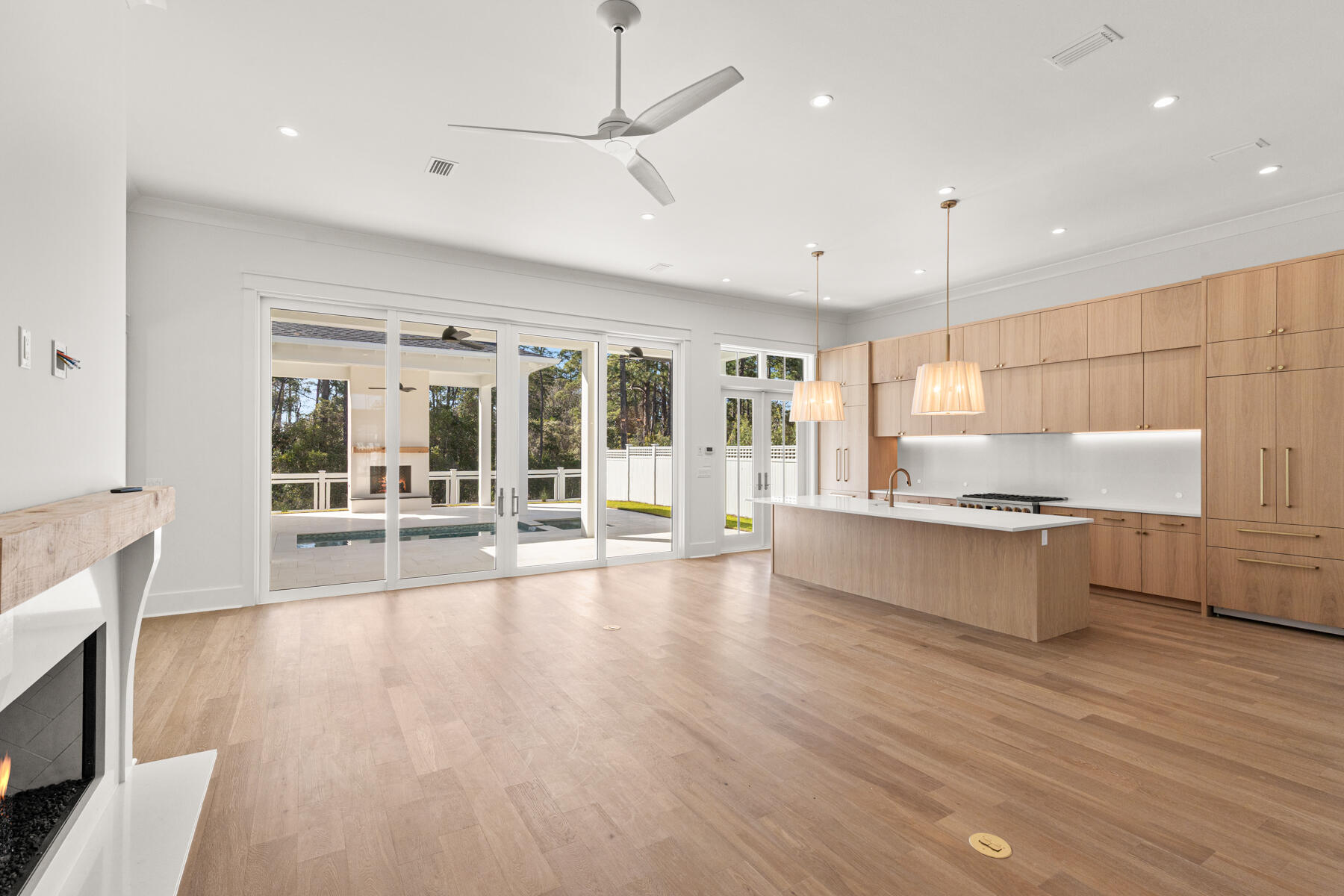 74 Pollard Cove West, Unit LOT 41 Watersound, FL 32461 - Photo 19 of 62 a large white kitchen with a large window a sink and stainless steel appliances
