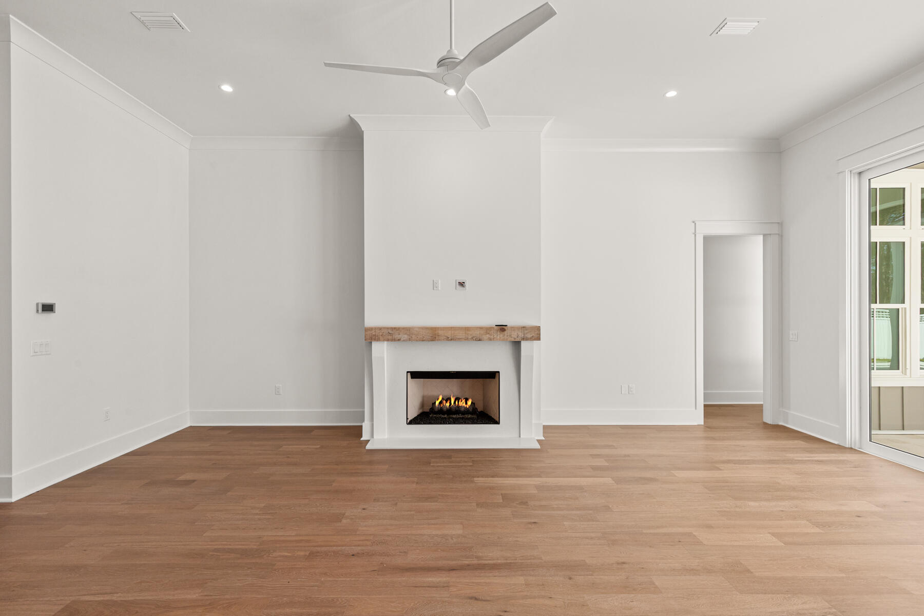 74 Pollard Cove West, Unit LOT 41 Watersound, FL 32461 - Photo 22 of 62 wooden floor fireplace and windows in an empty room