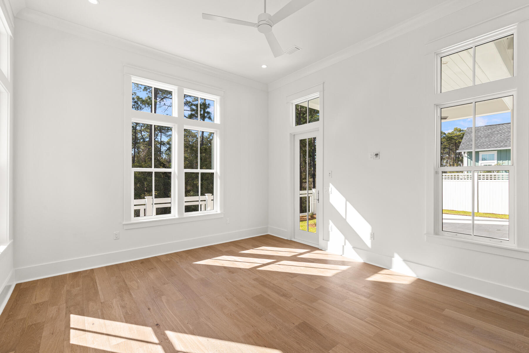 74 Pollard Cove West, Unit LOT 41 Watersound, FL 32461 - Photo 30 of 62 a view of empty room with wooden floor and fan