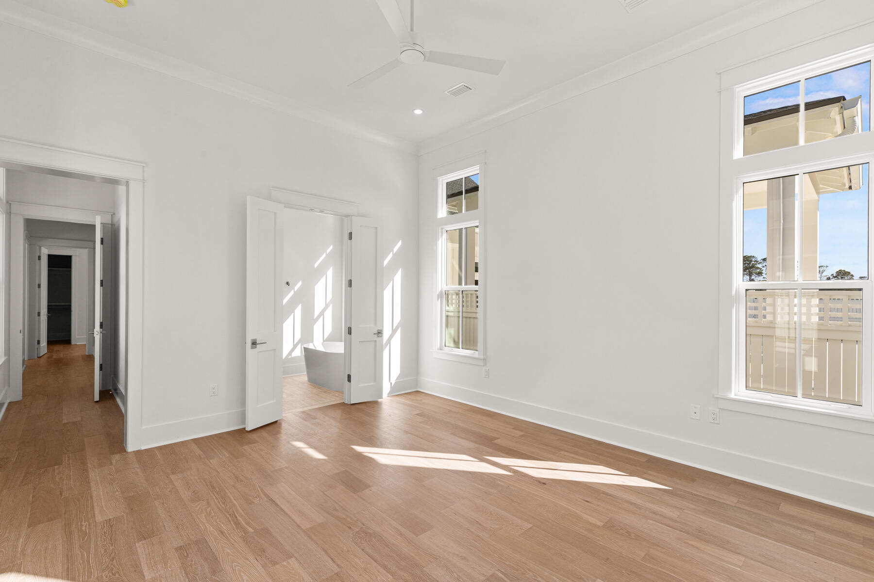 74 Pollard Cove West, Unit LOT 41 Watersound, FL 32461 - Photo 32 of 62 a view of empty room with wooden floor and fan