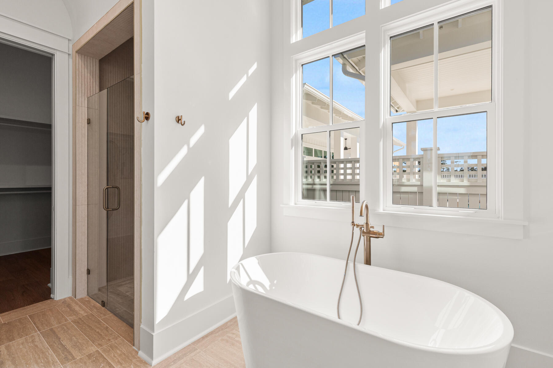74 Pollard Cove West, Unit LOT 41 Watersound, FL 32461 - Photo 34 of 62 a white bath tub sitting in a bathroom next to a window